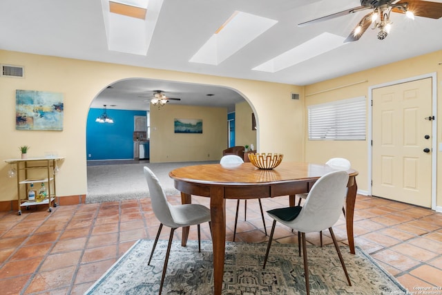 dining space featuring ceiling fan and tile patterned flooring