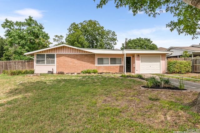 ranch-style house featuring a garage and a front yard