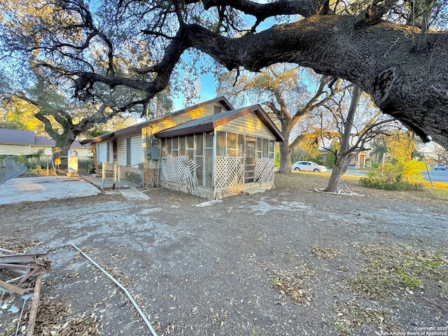 view of property exterior featuring a sunroom