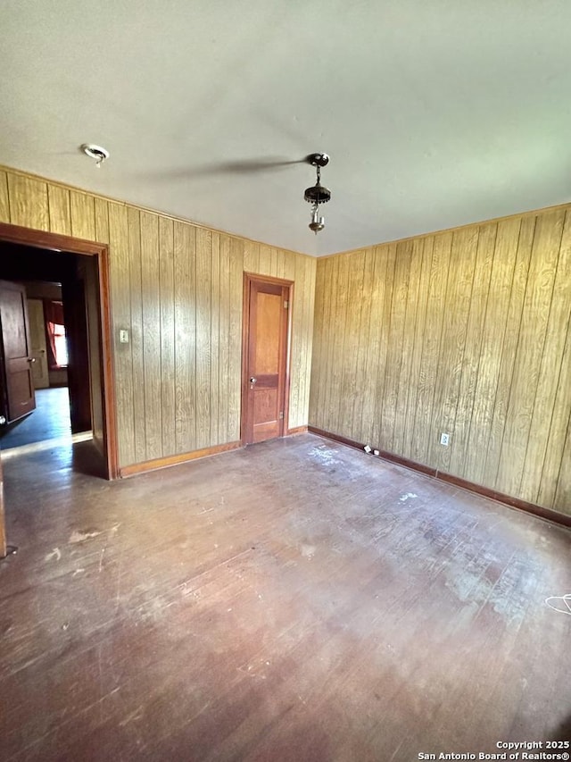 empty room featuring dark hardwood / wood-style floors and wooden walls