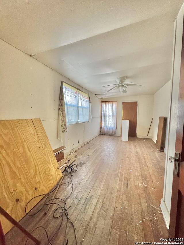 spare room featuring wood-type flooring and ceiling fan