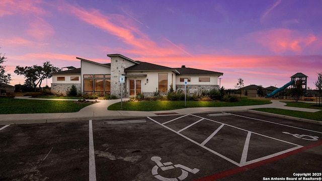 view of front of property with a playground