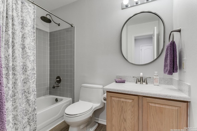 full bathroom with vanity, shower / tub combo, and toilet