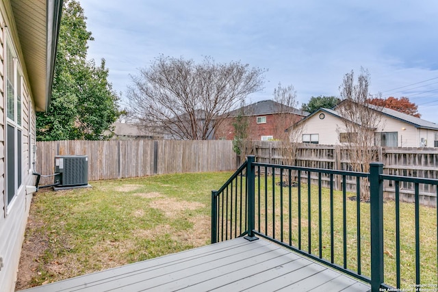 wooden terrace featuring a lawn and central air condition unit