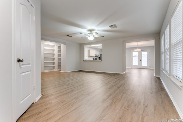 unfurnished living room with ceiling fan and light hardwood / wood-style flooring