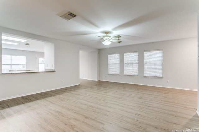 unfurnished room featuring ceiling fan and light wood-type flooring