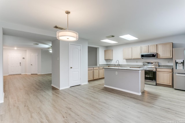 kitchen featuring sink, light hardwood / wood-style flooring, light brown cabinets, and appliances with stainless steel finishes