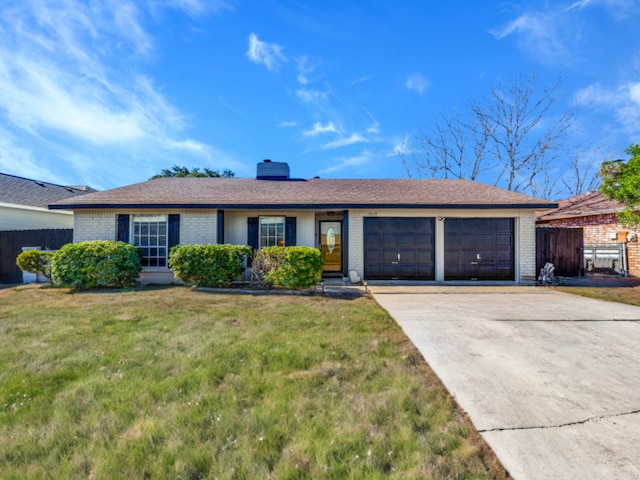 single story home with a garage and a front lawn