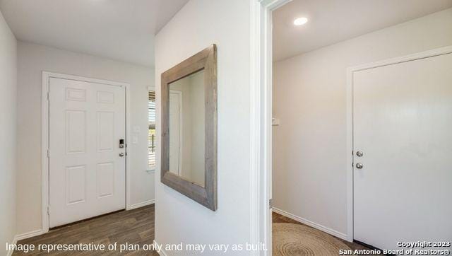 hall featuring baseboards, wood finished floors, and recessed lighting