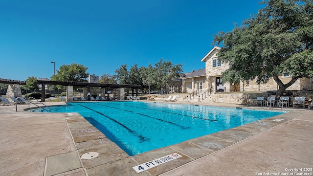 view of pool with a pergola and a patio area