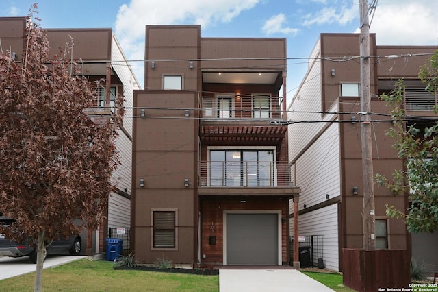 view of front of home featuring a garage and a balcony