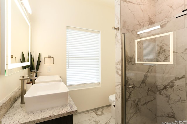 bathroom featuring vanity, a shower with shower door, and toilet