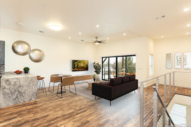 living room with hardwood / wood-style flooring and ceiling fan