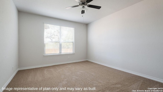 carpeted spare room featuring ceiling fan