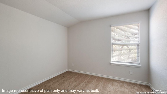 empty room featuring carpet and lofted ceiling