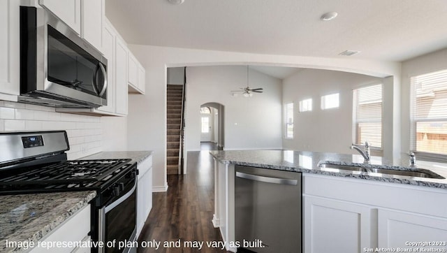 kitchen with white cabinetry, light stone counters, and appliances with stainless steel finishes