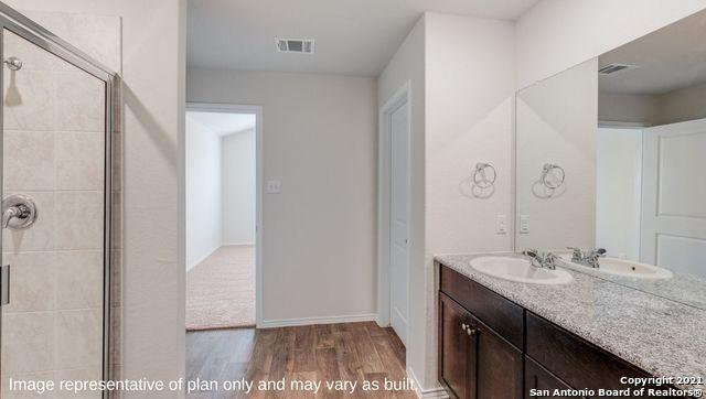 bathroom featuring a shower with door, vanity, and hardwood / wood-style floors