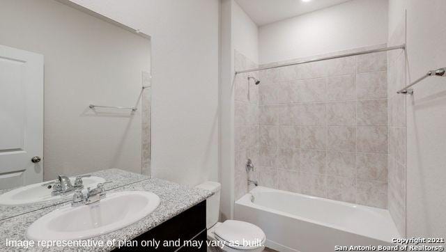 full bathroom with vanity, toilet, and tiled shower / bath combo