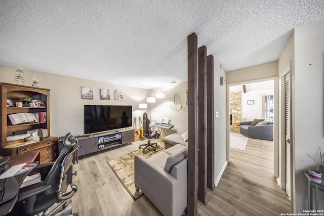 living room with hardwood / wood-style floors and a textured ceiling