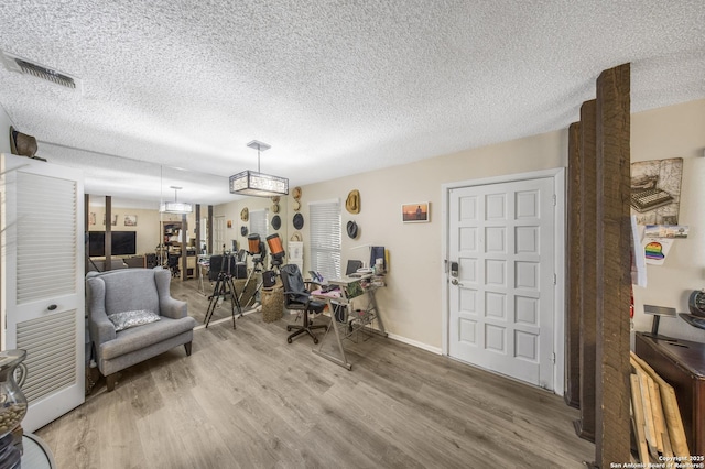 interior space with hardwood / wood-style floors and a textured ceiling