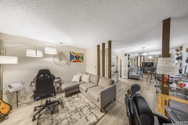 living room with wood-type flooring and a textured ceiling