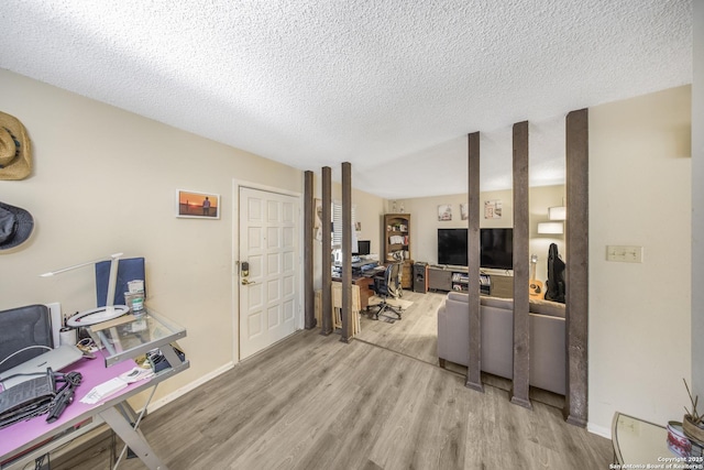 interior space featuring light hardwood / wood-style floors and a textured ceiling