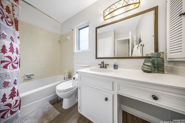 full bathroom featuring hardwood / wood-style flooring, vanity, shower / bathtub combination with curtain, and toilet