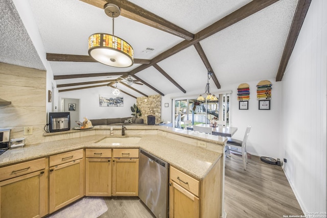 kitchen with sink, ceiling fan, decorative light fixtures, stainless steel dishwasher, and kitchen peninsula