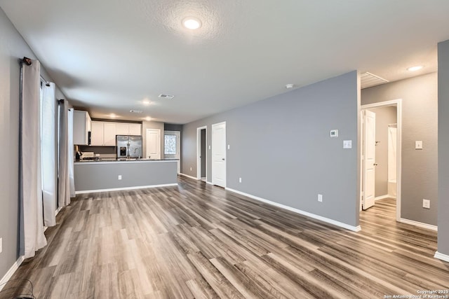 unfurnished living room featuring light wood-type flooring