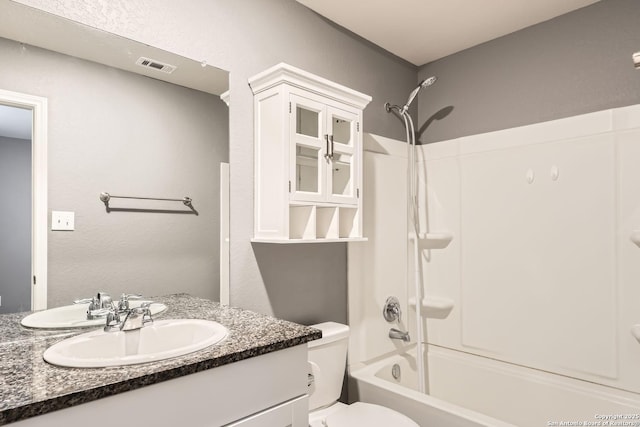 full bathroom featuring vanity, toilet, and washtub / shower combination