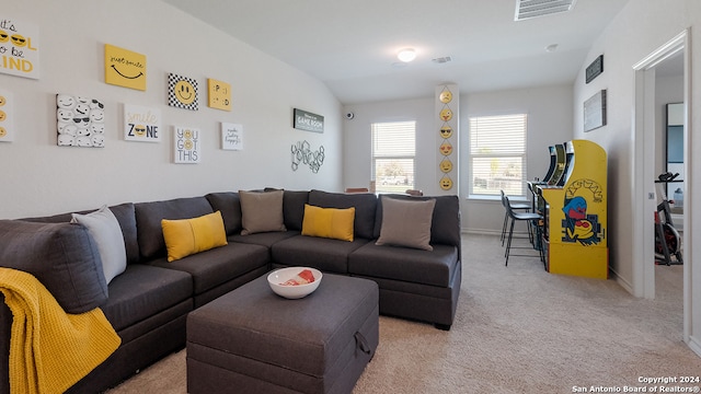 carpeted living room featuring vaulted ceiling