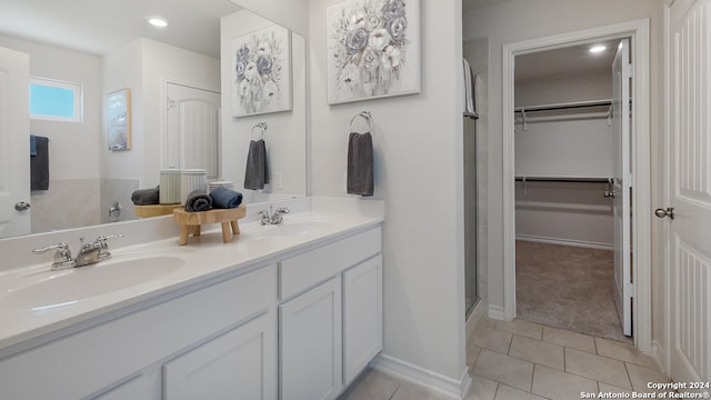 bathroom with vanity, a shower with shower door, and tile patterned floors