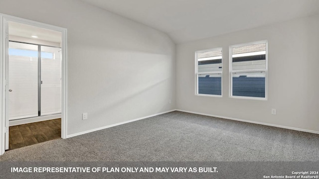 unfurnished room with vaulted ceiling and carpet flooring