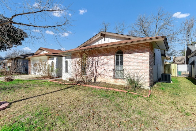 exterior space with a front yard and central air condition unit