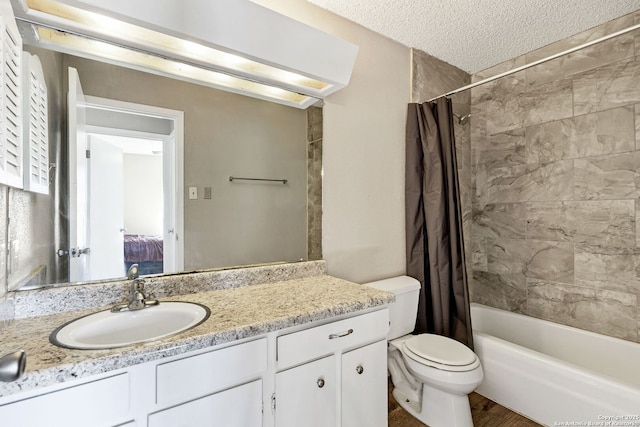 full bathroom featuring vanity, toilet, a textured ceiling, and shower / tub combo with curtain