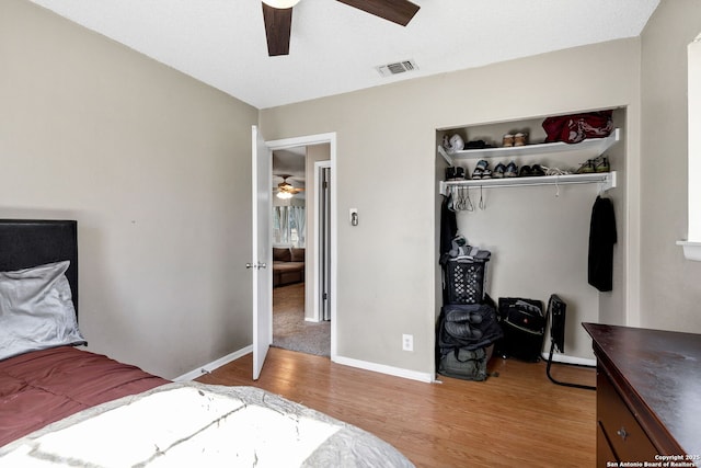 bedroom featuring ceiling fan, light hardwood / wood-style floors, and a closet