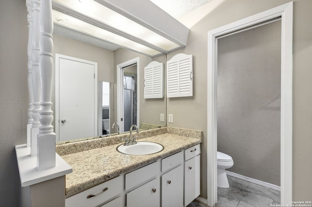 bathroom featuring vanity and toilet