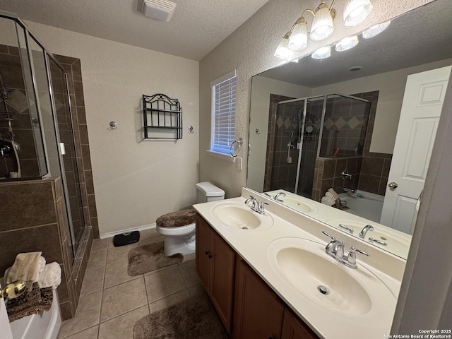 bathroom featuring a shower with shower door, tile patterned flooring, vanity, toilet, and a textured ceiling