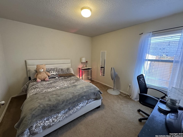 bedroom featuring carpet flooring and a textured ceiling