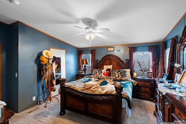 carpeted bedroom with crown molding, a textured ceiling, and ceiling fan