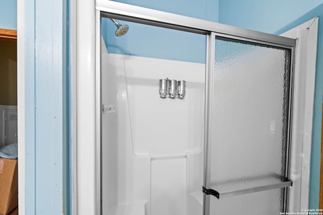 bathroom with a shower with shower door