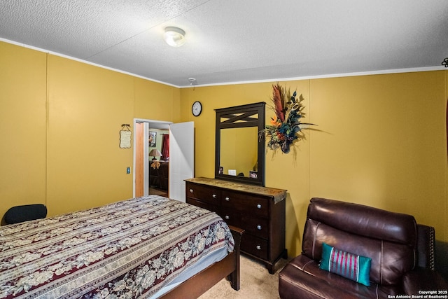 carpeted bedroom featuring ornamental molding and a textured ceiling