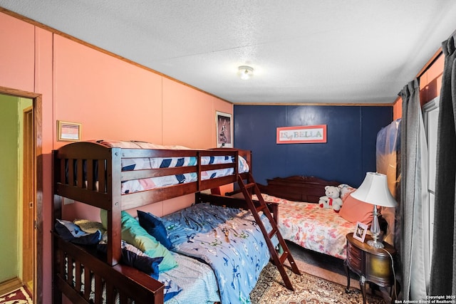 bedroom with ornamental molding and carpet