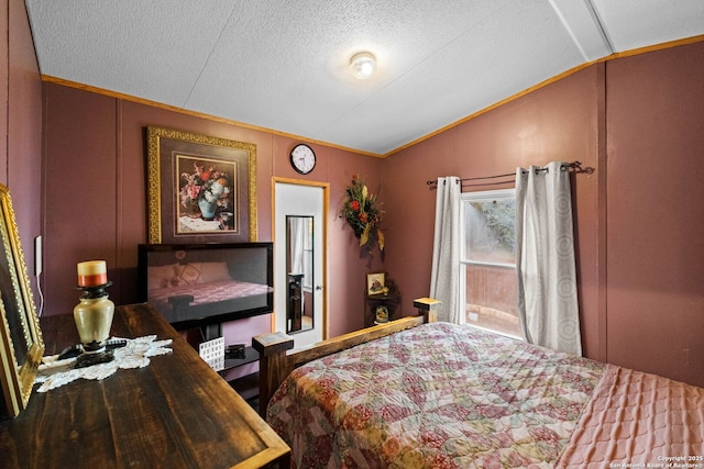 bedroom featuring lofted ceiling and a textured ceiling