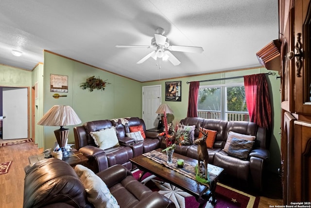 living room featuring wood-type flooring, lofted ceiling, ornamental molding, ceiling fan, and a textured ceiling