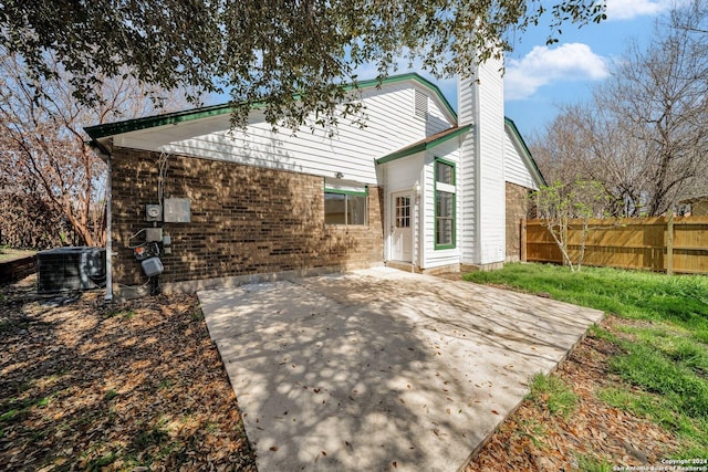 back of house featuring cooling unit and a patio