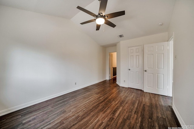 unfurnished bedroom with vaulted ceiling, dark wood-type flooring, ceiling fan, and a closet