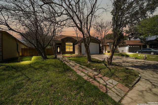 view of front of property featuring a garage and a lawn