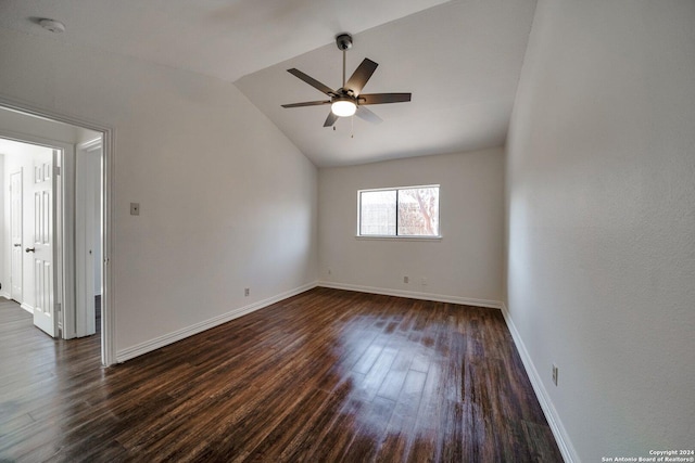 empty room with vaulted ceiling, dark wood-type flooring, and ceiling fan