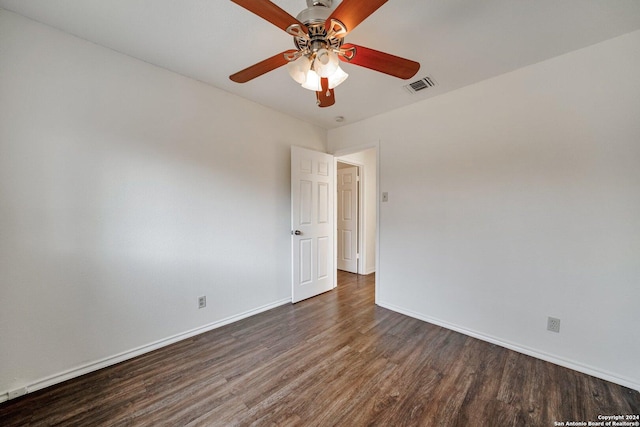 unfurnished room with dark hardwood / wood-style flooring and ceiling fan